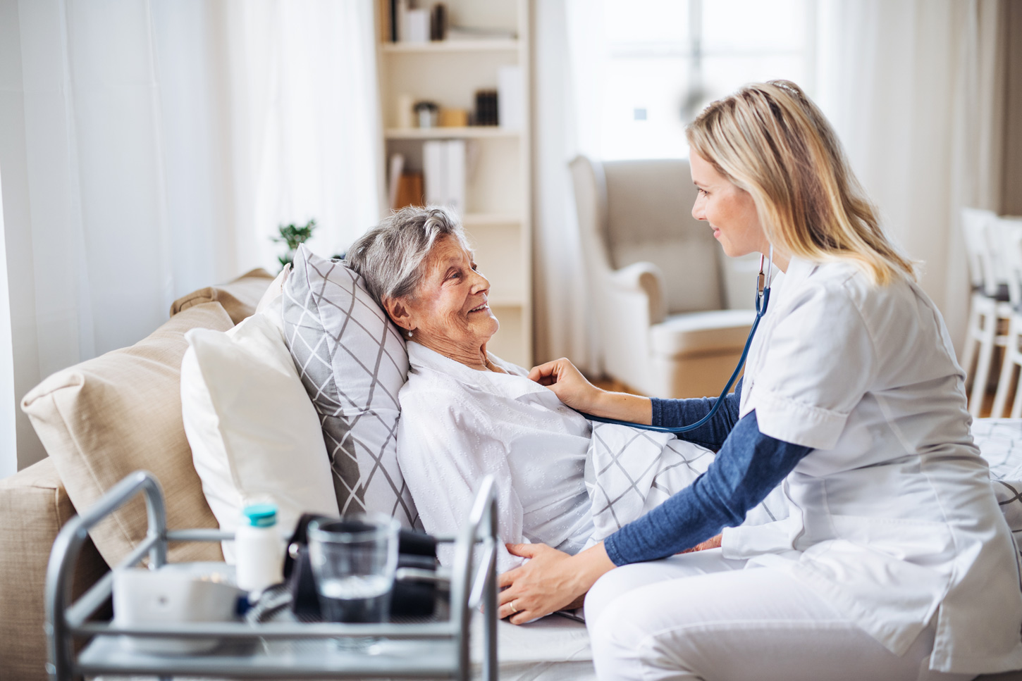 Home health practitioner attending to an elderly woman