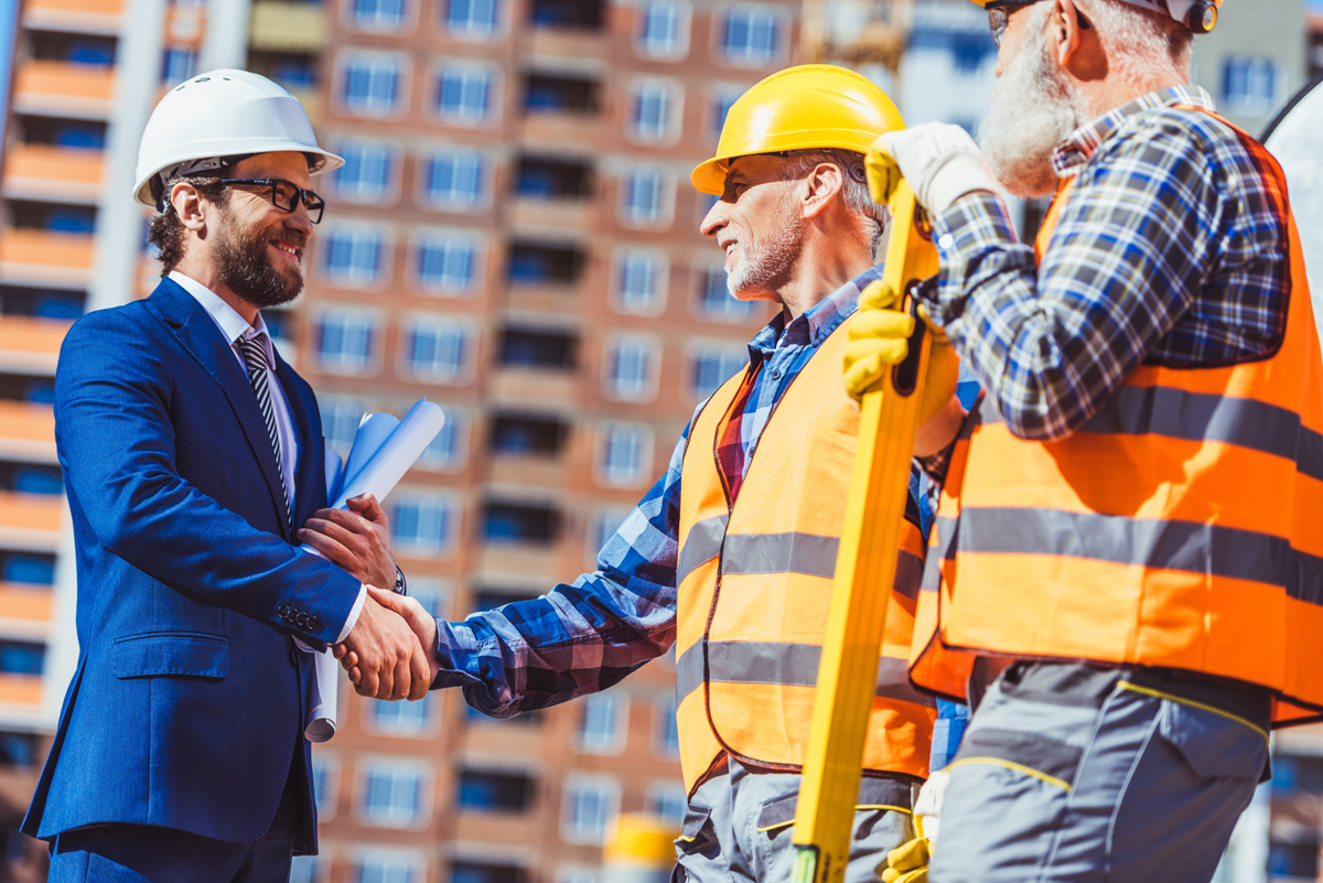 Wichita contractor with a bond shaking hands with subcontractors