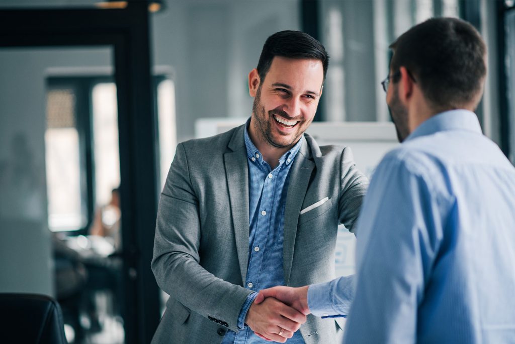 Notary in Kansas shaking hands with a signee