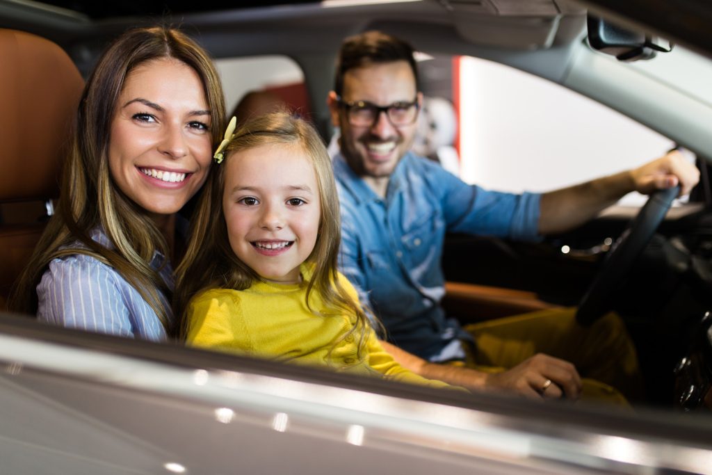 Family at a bonded auto dealership testing car
