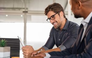 Small business owner smiling because he was just approved for a surety bond with collateral