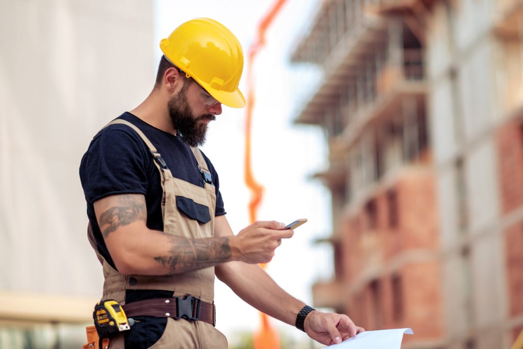 Contractor prequalifying for construction bond on his phone