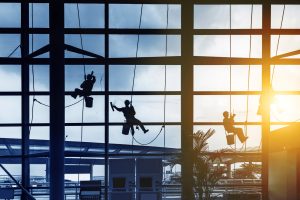 Workers cleaning windows with a company that has an NCP bond