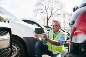 Bonded insurance adjuster in Iowa inspecting a car
